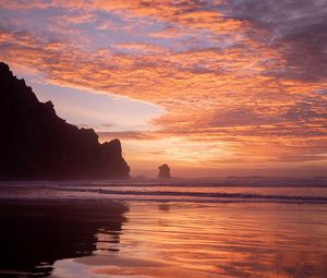 Preview wallpaper slope, rocks, sunset, sea, clouds, reflection