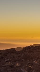 Preview wallpaper slope, sunset, stones, hills, sky