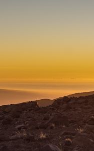 Preview wallpaper slope, sunset, stones, hills, sky