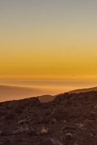 Preview wallpaper slope, sunset, stones, hills, sky