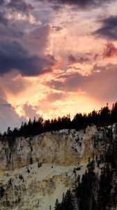 Preview wallpaper slope, trees, sunset, rocks, clouds