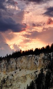 Preview wallpaper slope, trees, sunset, rocks, clouds