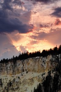 Preview wallpaper slope, trees, sunset, rocks, clouds