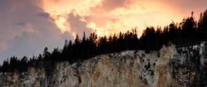 Preview wallpaper slope, trees, sunset, rocks, clouds