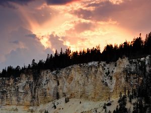 Preview wallpaper slope, trees, sunset, rocks, clouds