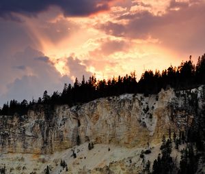 Preview wallpaper slope, trees, sunset, rocks, clouds