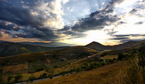 Preview wallpaper slope, valley, road, mountains, clouds