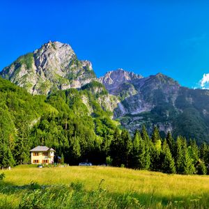 Preview wallpaper slovenia, mountains, lodges, meadow, green, brightly, sky, blue, clearly