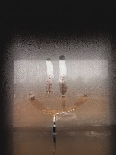 240x320 Wallpaper smile, smiley, glass, wet, window, drops