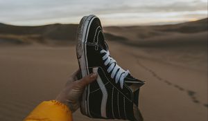 Preview wallpaper sneaker, sand, hand, shoes, desert
