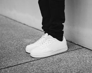 Preview wallpaper sneakers, legs, bw, minimalism