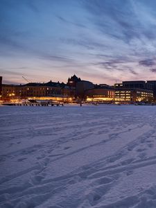 Preview wallpaper snow, buildings, lights, winter, evening