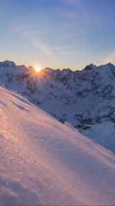 Preview wallpaper snow, sun, rays, rocks, slope