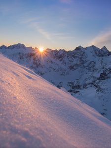 Preview wallpaper snow, sun, rays, rocks, slope