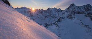 Preview wallpaper snow, sun, rays, rocks, slope