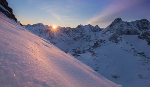 Preview wallpaper snow, sun, rays, rocks, slope