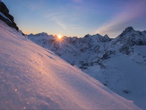 Preview wallpaper snow, sun, rays, rocks, slope