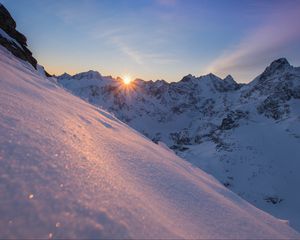 Preview wallpaper snow, sun, rays, rocks, slope