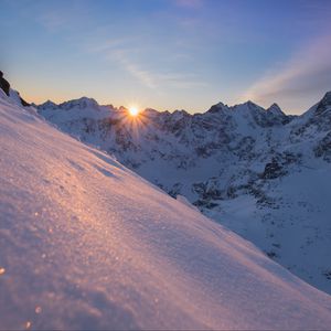 Preview wallpaper snow, sun, rays, rocks, slope