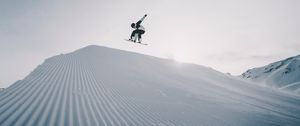 Preview wallpaper snowboarder, snowboard, helmet, snow, jump