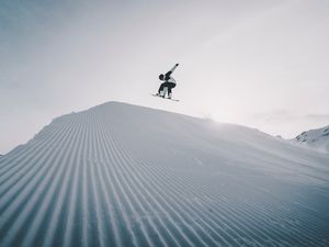 Preview wallpaper snowboarder, snowboard, helmet, snow, jump