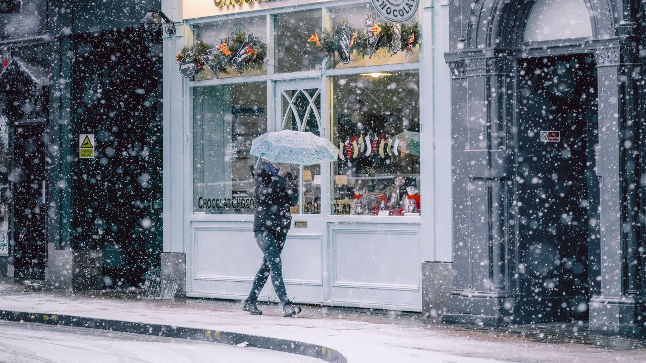 Wallpaper snowfall, man, buildings, street, walk