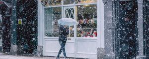 Preview wallpaper snowfall, man, buildings, street, walk