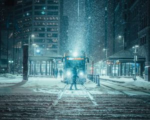 Preview wallpaper snowfall, night, city, transport, winter