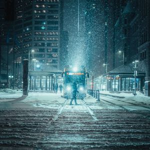 Preview wallpaper snowfall, night, city, transport, winter