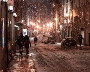 Preview wallpaper snowfall, people, street, night, evening, city, winter