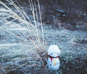 Preview wallpaper snowman, christmas, new year, toy, grass, blur
