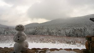 Preview wallpaper snowman, winter, mountains, trees, fog, clouds