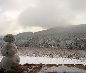 Preview wallpaper snowman, winter, mountains, trees, fog, clouds