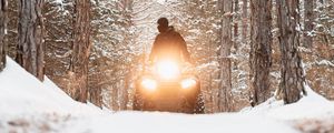 Preview wallpaper snowmobile, black, man, forest, snow, winter