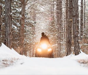 Preview wallpaper snowmobile, black, man, forest, snow, winter