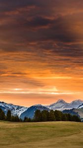 Preview wallpaper snowy mountains, sunset, grass, sky