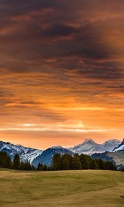 Preview wallpaper snowy mountains, sunset, grass, sky