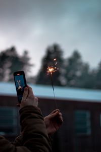 Preview wallpaper sparkler, hand, phone, sparks