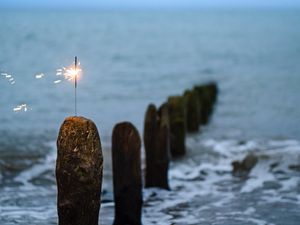 Preview wallpaper sparkler, sparks, sea, stones