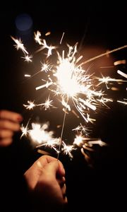 Preview wallpaper sparklers, hand, sparks, glow, dark