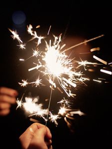 Preview wallpaper sparklers, hand, sparks, glow, dark