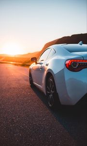 Preview wallpaper sports car, car, rear view, road, sunset