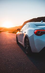 Preview wallpaper sports car, car, rear view, road, sunset