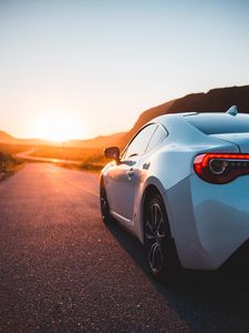 Preview wallpaper sports car, car, rear view, road, sunset