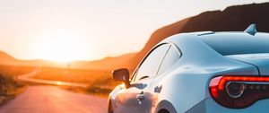 Preview wallpaper sports car, car, rear view, road, sunset