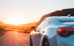 Preview wallpaper sports car, car, rear view, road, sunset