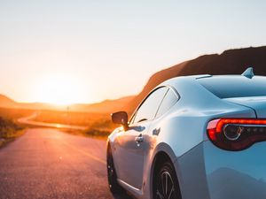 Preview wallpaper sports car, car, rear view, road, sunset