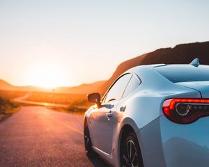 Preview wallpaper sports car, car, rear view, road, sunset