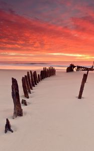 Preview wallpaper stakes, columns, sand, beach, outflow, evening, silence