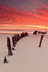 Preview wallpaper stakes, columns, sand, beach, outflow, evening, silence